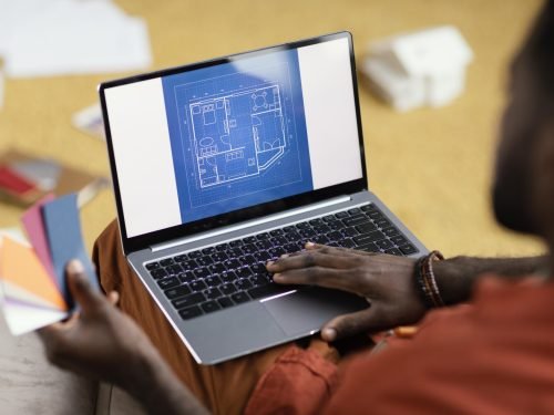 man-making-plans-renovate-house-using-color-palette-laptop